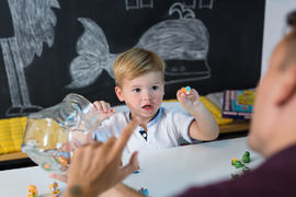 Cute little toddler boy at speechtherapist session.