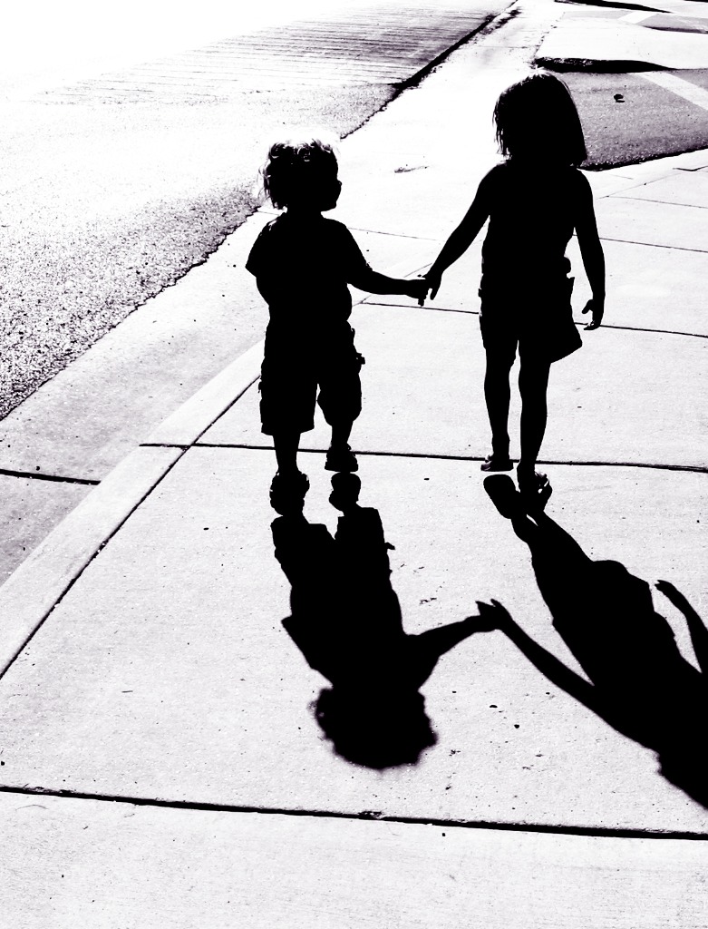 adorable-children-silhouettes-boy-and-girl-holding-hands-picture-id121351839.jpg