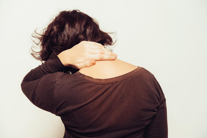 FØLGEPLAGER: Stive skuldre er en av mange følgeplager som rammer hørselshemmede. Illustrasjonsfoto. Colourbox