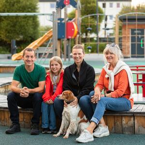 Foto av en familie som valgte å flytte til Brumunddal foran lekeparken i Broparken
