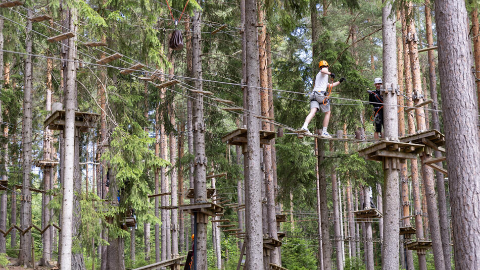 Person som klatrer i en klatrepark