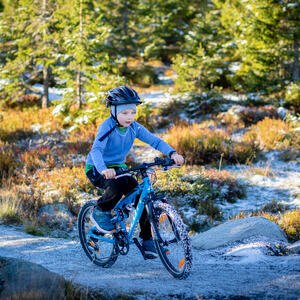 Foto av barn på sykkel i fjellet