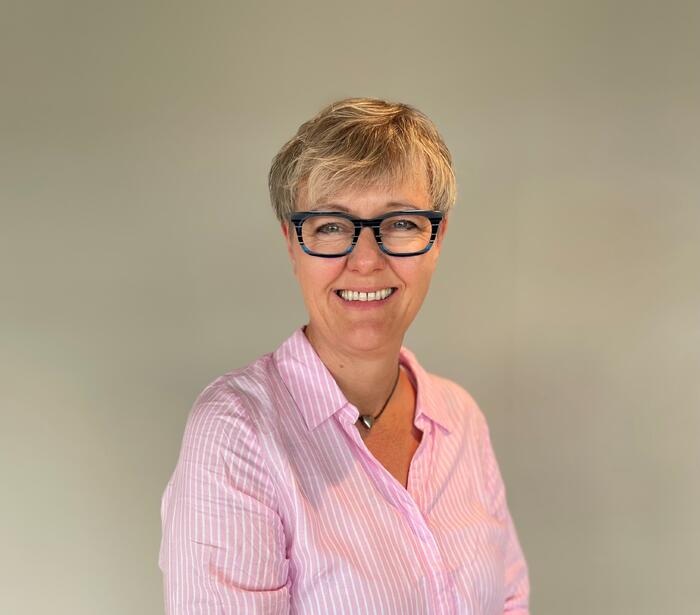 Dame i rosa overdel og kule briller